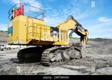 big yellow excavator or digger for coal ore in mining site at borneo Stock Photo