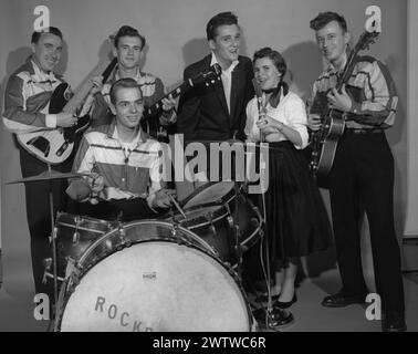 Portrait of a 1950's 6 piece rockabilly band consisting of five men and a woman Stock Photo