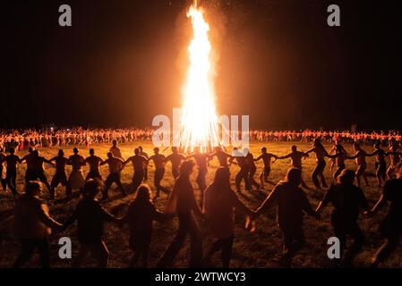 Solstice celebration, big bonfire and round dance at night Stock Photo