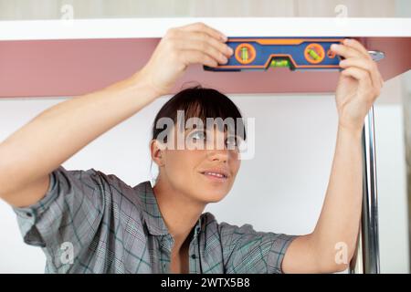 closeup of a young woman using spirit level Stock Photo