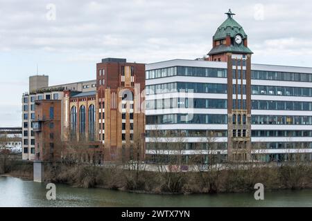 Plange Mill with historic harbor clock at the Medienhafen (media harbor), building with offices and lofts, Duesseldorf, Germany. Plange Muehle mit his Stock Photo