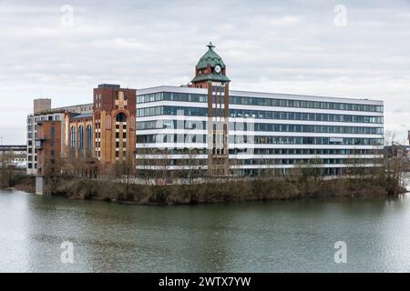 Plange Mill with historic harbor clock at the Medienhafen (media harbor), building with offices and lofts, Duesseldorf, Germany. Plange Muehle mit his Stock Photo