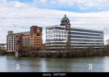 Plange Mill with historic harbor clock at the Medienhafen (media harbor), building with offices and lofts, Duesseldorf, Germany. Plange Muehle mit his Stock Photo