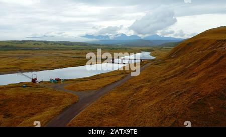 Magical rural landscape in autumn. Clip. Aerial shot of the river flowing across the yellow valley. Stock Photo