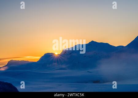 sun setting behind the mountains of the Jotunheim / Jotunheimen, Norway Stock Photo