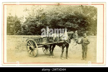 Original sepia toned Victorian carte de visite (visiting card or CDV) of country image of long ago, a rustic farmhand standing next to a Victorian horse and cart, with a young boy, possibly his son, taking a ride in the cart. Victorian carter. Albumen photograph Circa 1860's. U.K. Stock Photo