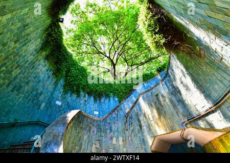 View of a spiral staircase of an underground crossing in tunnel at Fort Canning Park, Singapore Stock Photo