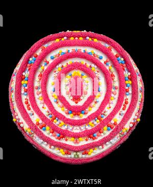 lollipop covered with a multicolored coating of sugar candy pearls in the colors of the rainbow Stock Photo