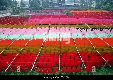 March 19, 2024, Dhaka, Wari, Bangladesh: Bangladeshi workers collect fabric after drying them under the sun at a dyeing factory in Narayanganj, near Dhaka, Bangladesh, on March 20, 2024. (Credit Image: © Habibur Rahman/ZUMA Press Wire) EDITORIAL USAGE ONLY! Not for Commercial USAGE! Stock Photo