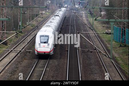 Eschede, Germany. 20th Mar, 2024. An ICE train travels on the railroad line between Hanover and Hamburg. Both sides in the wage dispute at Deutsche Bahn have resumed negotiations. The Group and the train drivers' union GDL are confident of reaching an agreement this week, according to a statement from Deutsche Bahn. Credit: Julian Stratenschulte/dpa/Alamy Live News Stock Photo