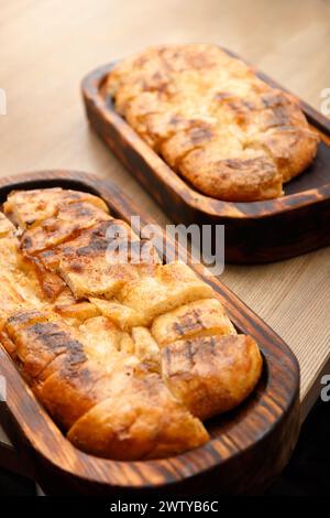 Fresh pita bread on a wooden board on a table. Lavash cooked in the oven. Stock Photo