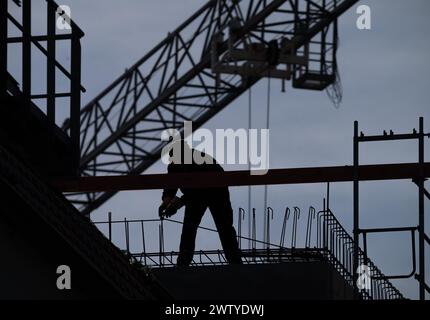 Berlin, Germany. 19th Mar, 2024. A worker is busy on a construction site in Weißensee. The IMK economic forecast by the Hans Böckler Foundation is to be presented at a press conference on March 21. Credit: Soeren Stache/dpa/Alamy Live News Stock Photo