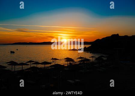 Beautiful sunset on Pefkos beach on the island of Rhodes in Greece. Stock Photo