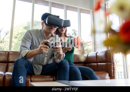 The young couple is having a great time playing VR games at home Stock Photo