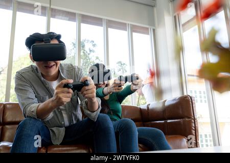 The young couple is having a great time playing VR games at home Stock Photo