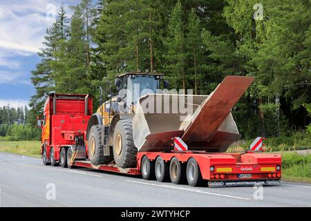 Scania truck PHP Group hauls Cat 980K wheel loader with bucket and attachment Nooteboom low loader trailer, rear view. Forssa, Finland. Aug 11, 2022. Stock Photo