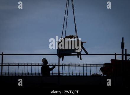 Berlin, Germany. 19th Mar, 2024. A worker is busy on a construction site in Weißensee. According to a new forecast by the economic research institute IMK, the German economy will shrink by 0.3 percent this year. Credit: Soeren Stache/dpa/Alamy Live News Stock Photo