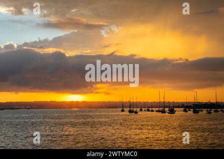 Silhouettes of boats at sunset in San Diego Bay, California Stock Photo