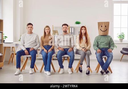 People Seated in a Row Paper Bag with a Smiling Face Stock Photo