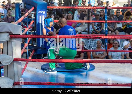 Oaxaca, Mexico - A coach prepares a boy for a youth boxing match in the zocalo. Stock Photo