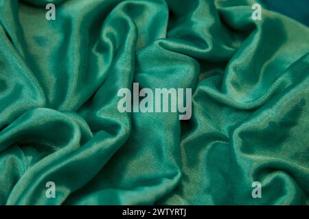Soft green silk fabric with numerous gentle folds Stock Photo