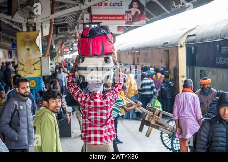 Porters moving goods at a railway station in North East India Stock Photo