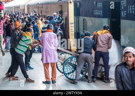 Porters moving goods at a railway station in North East India Stock Photo