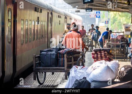 Porters moving goods at a railway station in North East India Stock Photo