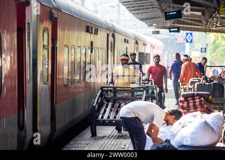 Porters moving goods at a railway station in North East India Stock Photo