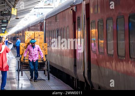 Porters moving goods at a railway station in North East India Stock Photo