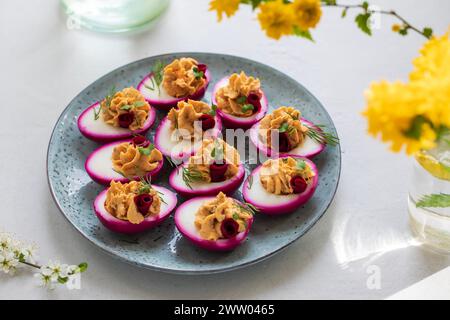 Beetroot pickled devilled eggs, easter canapes Stock Photo