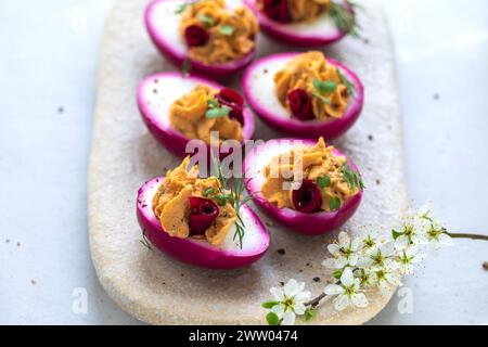 Beetroot pickled devilled eggs, easter canapes Stock Photo