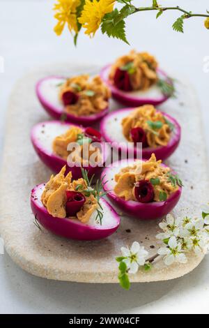 Beetroot pickled devilled eggs, easter canapes Stock Photo