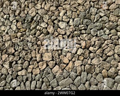 Texture of a rock wall built with the ancient dry stone technique. All stones are fitted together without concrete. Stock Photo