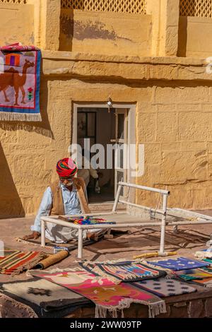 Jodhpur, India - December 18.2023: A old man selling handmade carpet at the Mehrangarh Fort in Jodhpur, Rajasthan Stock Photo