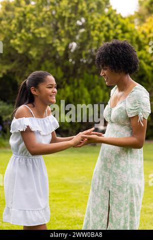 Mother and daughter share a joyful moment at a winter fair Stock Photo