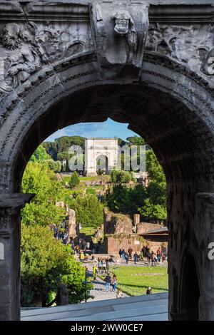 Roman Forum ancient ruins with the Arch of Titus view through the Arch of Septimius Severus Stock Photo