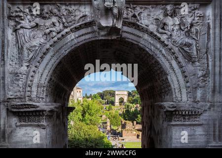 Roman Forum ancient ruins with the Arch of Titus view through the Arch of Septimius Severus Stock Photo