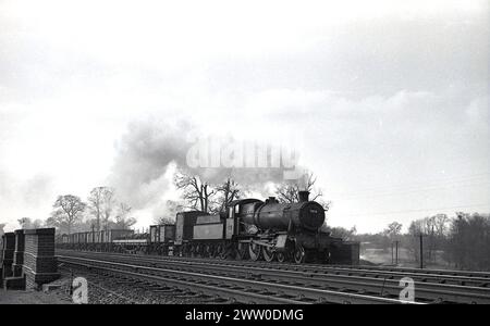 1950s, historical, Briitsh Railways steam locomotive, 7816 a GWR Manor Class on the rail track, pulling freight wagons, England, UK. Built at the Swindon Works in 1939, it was in service until being withdrawn in 1965. Stock Photo