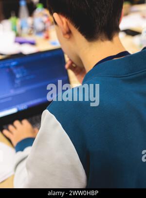 Software developer students in auditorium hall working on computer and laptop, programming contest hackathon competition, pc with coding program app, Stock Photo