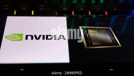 Viersen, Germany - March 18. 2024: Closeup of smartphone on computer Keyboard with log lettering of Nvidia and symbol for new Blackwell GPU B200 preoc Stock Photo