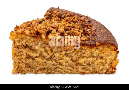 Hazelnut sponge cake, view of slice with roasted hazelnut kernels on top, isolated on white with clipping path included Stock Photo