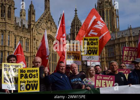 London, UK. 20th Mar, 2024. Protesters hold 'No more P&Os' placards and trade union flags during the demonstration. Members of the trade unions RMT, TUC and Nautilus gathered outside the Parliament on the second anniversary of P&O Ferries firing nearly 800 workers, calling for a new deal for workers and an end to Fire and Rehire. Credit: SOPA Images Limited/Alamy Live News Stock Photo