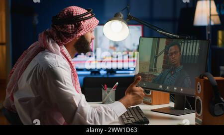 Arab teleworker in video call session with therapist, asking for advice, feeling down. Remotely working muslim employee in online consultation with psychologist from stylish cozy home Stock Photo