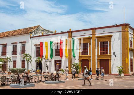 Cartagena, Colombia - July 25, 2023: Plaza de San Pedro Claver, square. Museo del arte moderno, modern art museum with flags, metal artwork and coloni Stock Photo