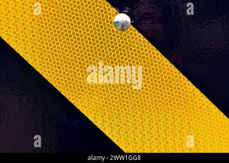 Caution sign, warning sign witn yellow and black stripes (detail) Stock Photo