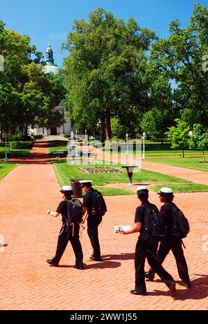 Midshipman at the US Naval Academy in Annapolis walk across their campus in uniform Stock Photo