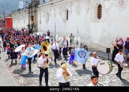 Antigua, Guatemala. 20th Mar, 2024. The Semana Santa Festival Queen, surrounded by school children parades through the historic center in preparation for Holly Week, March 20, 2024 in Antigua, Guatemala. The opulent processions, detailed alfombras and centuries-old traditions attract more than 1 million people to the ancient capital city. Credit: Richard Ellis/Richard Ellis/Alamy Live News Stock Photo