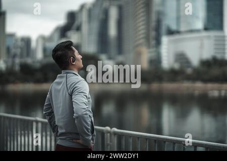 Men stretch their muscles and breathe in the morning air in a city center park before doing cardio and running. Health and lifestyle in the concept of Stock Photo