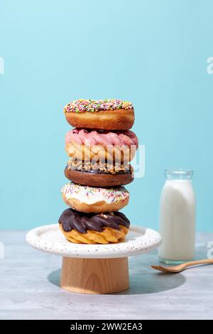 A stack of donuts on a wooden stand with milk Stock Photo